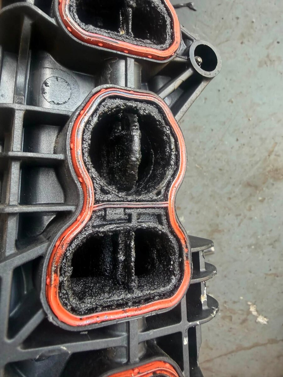 Carbon-clogged diesel intake manifold removed for cleaning at ASR