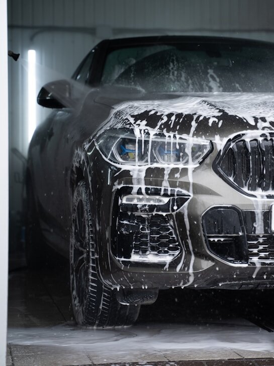 Car covered in snow foam during a maintenance wash